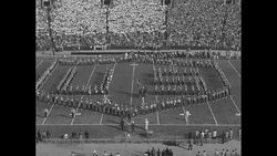 Fans at the 1954 Rose Bowl hold up cards to form patterned displays News Clip