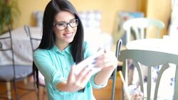 Woman in glasses taking a selfie Stock Footage