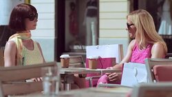 TU Two female friends talking over coffee in the sun Stock Footage