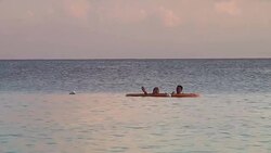 Tourists relaxing on Grand Cayman beach News Clip