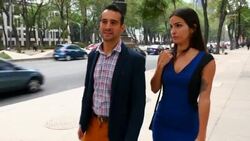 MS TS Smiling couple in discussion while walking on city sidewalk Stock Footage