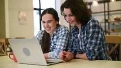 Two beautiful girls with laptop Stock Footage