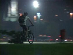 MS, TS, Brazil, Rio de Janeiro, Man riding bicycle on street at night, rear view Stock Footage