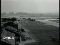 1942: WWII EASTERN ENGLAND: HA XWS United States Army Air Forces base, 8th Air Force field. WS (POV Behind shrubs) B-17 'Flying Fortress' bomber parked on field. Women standing by fencing FG, US B-17 crew walking toward bomber. Instructional Video