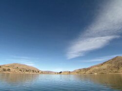 View from boat on Lake Titicaca with blue skies, near Tiwanaku Tiahuanaco/Tiahuanacu, Bolivia Stock Footage
