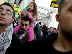 January 23, 2009 CU Men listening to speaker during protest against Israel's attack on Gaza Strip as man holds daughter on shoulders behind them/ Washington DC/ AUDIO Stock Footage