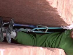 ECU Climber in wide crack moving his protection pieces up the rock, rope attaching to pieces of gear / Zion,UT,USA Stock Footage