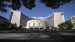 pedestrians walk past the headquarter office building of People's Bank of China Stock Footage