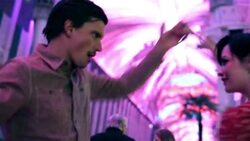 Young couple waltz romantically under the bright lights of downtown Las Vegas Stock Footage