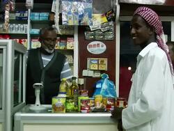 MS Shot of cashiers desk and products being scanning with red laser / Djibouti Stock Footage
