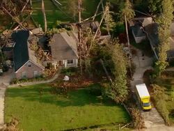 Sept. 11, 2005 aerial fallen trees on house and car in aftermath of Hurricane Katrina / Louisiana Stock Footage