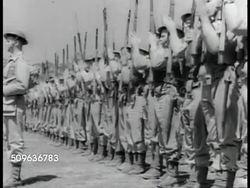 1941: ANZACS (AUSTRALIAN & NEW ZEALAND ARMY CORPS) DRILLING: VS Many soldiers drilling w/ rifles. MS Australian Officer. Australian soldiers in uniform w/ rifles on shoulders marching. Line of marching soldiers w/ other soldiers standing BG. Instructional Video