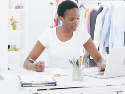 HD: Female Fashion Designer Working At Laptop. Stock Footage