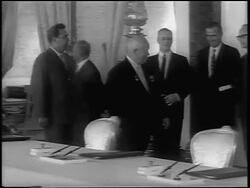 B/W 1963 Nikita Khrushchev walking past diginitaries in ornate room to sign Atomic Test Ban Treaty Stock Footage