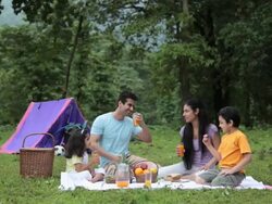 Family drinking juice in a forest, Malshej Ghat, Maharashtra, India Stock Footage