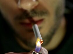 CU Shot of young man lighting cigarette and smoking / Rome, Lazio, Italy Stock Footage