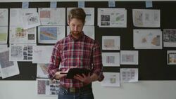 MS Smiling businessman holding digital tablet in front of project board in conference room Stock Footage