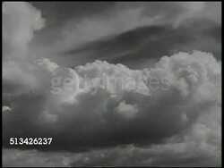 1943: NEW BRITAIN CAMPAIGN: VS U.S. Coastwatcher surveying landscape from top of hill, clouds overhead, male Coastwatcher walking through native village, entering hut, transmitting information via radio. Field intelligence, WWII, Pacific Front Instructional Video