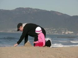 Building, Constructing Sand Castle on the Beach: Mother, Daughter, Generations Stock Footage