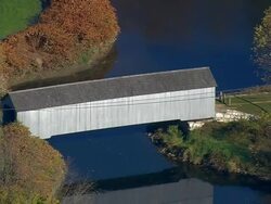 MS AERIAL DS Shot of covered bridge on river / Massachusetts, United States Stock Footage