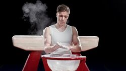 SLO MO Male gymnast clapping chalky hands together Stock Footage