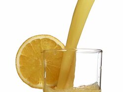 CU SLO MO Orange juice pouring into glass against white background / Vieux Pont, Normandy, France Stock Footage