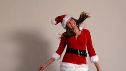 Cute girl in santa costume jumping and smiling Stock Footage