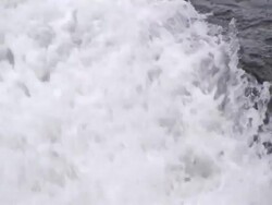 Close Up tilt-down - Water cascades down a rocky stream bed / Alaska, USA Stock Footage