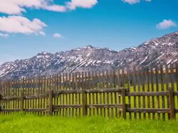 Time lapse of clouds moving over mountains and fence Stock Footage