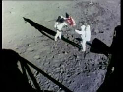 Apollo 11 astronauts, Buzz Aldrin and Neil Armstrong, putting up the American flag, high angle, Moon Stock Footage