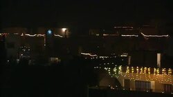 Strings of lights flash across rooftops as fireworks explode during a Diwali celebration in India. Stock Footage