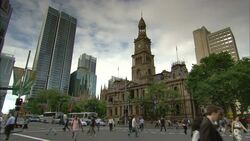 Pedestrians cross Town Hall Junction in Sydney, Australia. Stock Footage