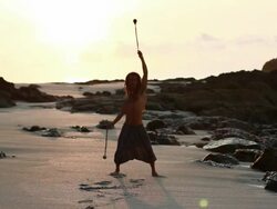 MS Rasta man spinning wide circles on beach with sunrise and ocean  / Montezuma, Punteranes, Costa Rica Stock Footage