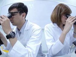HD : Scientist Couple using microscope Stock Footage