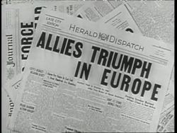 Newspaper headlines announce the surrender of Germany in World War Two. News Clip