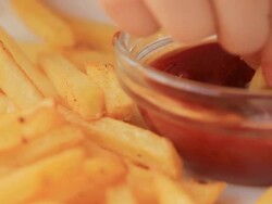 Taking French fries with ketchup from the plate Stock Footage