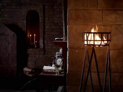 A fire burns in a lamp as Nostradamus writes at his desk. Stock Footage
