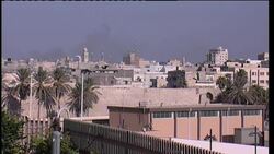 Smoke rises from pro-Gadhafi area where gunbattle is reported News Clip