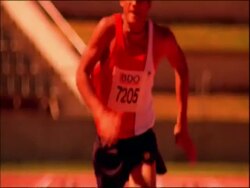 MS tilt up to athletes running to camera on track, dipping for finish, Australia Stock Footage