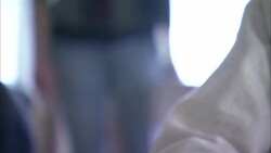 A drug user holds a syringe as a visitor stands behind. Stock Footage