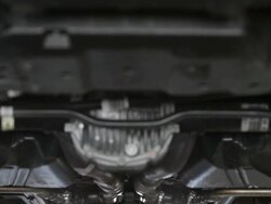 MS TD Mechanic working underneath car with his arms above his head within vehicle / Seattle, Washington, United States  Stock Footage
