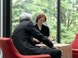 MS businessman in discussion over documents businesswoman smiling/Seattle, Washington, USA Stock Footage