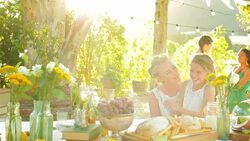 Bride and flower girl hugging and talking at wedding reception Stock Footage