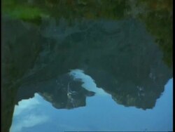 CU mountain reflected on surface of lake, Uganda, Africa Stock Footage