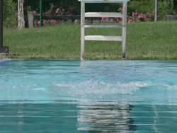 CU SLO MO Shot of Woman in swim cap swimming breast stroke / Davis, California, United States  Stock Footage