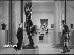 1948: SAN FRANCISCO, CALIFORNIA: CULTURAL INSTITUTIONS: WS Fine Arts Museum. WS People walking in gallery w/ statue FG, paintings in room BG. People looking at Rembrandt portrait painting of man with long beard. CU Metal tag 'Rembrandt  Van Rijn' Instructional Video
