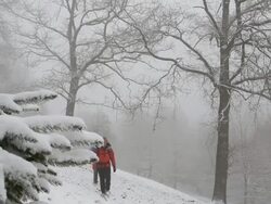 Boom shot of father and son hiking in snowstorm Stock Footage