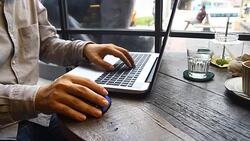 close up hand working on laptop on wood table Stock Footage