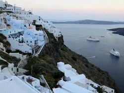 Cruise ships in the bay overlooked by the white washed houses of Thira, Aegean Sea on the Island of Santorini, Greece, Europe Stock Footage