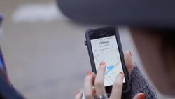 Young woman moves map around with her fingers on smartphone touchscreen Stock Footage